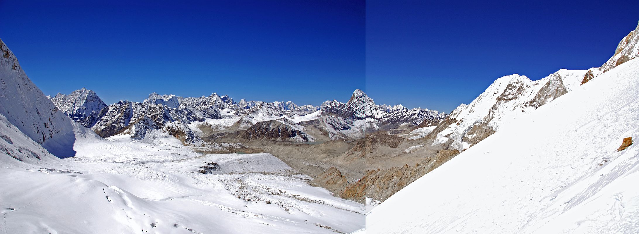 10 17 Peak 41, Hongu Peak, Peak 43 Kyashar, Malanphulan, Kangtega, Ombigaichen, Ama Dablam, Gauri Shankar, Menlungtse, Taweche From West Col From the top of the West Col (6135m), the view from southwest to north included P6770, Peak 41, Hongu Peak, Peak 43 Kyashar, Malanphulan, Kangtega, Khatang and Numbur, Tengkangpoche, Panalotapa, Bigphera Go Shar, Mingbo La, Tengi Ragi Tau, Ombigaichen and Ama Dablam, Gauri Shankar, Drangnag Ri, Menlungtse, and Taweche. The Amphu Labtsa (Lapcha) Pass (5780m) to the Chukung Valley is to the left of the long ridge descending from Baruntse. Baruntse Base Camp is next to the lake in the centre.